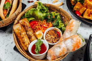 Delicious vietnamese food including pho ga, noodles, spring rolls on white wall